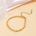 Elegant gold bead chain bracelet with adjustable extension and lobster clasp closure - Glass Bead Chain (E40) / Gold