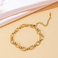 Detail view of a gold oval link chain bracelet with polished finish and extension chain - Round Cuban Chain (E61) / Gold