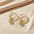 Elegant gold heart pendant hoop earrings displayed on premium beige silk fabric texture - Gold