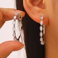 Silver round hoop earrings with marquise-cut white zircons worn on model - Marquise Zircon Hoop (2943) / Silver