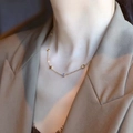 Elegant 18K gold-plated titanium necklace with blue gemstone and star pendant on a model - Colorful Rhinestone Clover Necklace (QYH1170) / Gold
