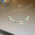 Close-up of elegant gold bracelet featuring multi-colored rectangular pastel crystals. - Style 3# Gold Colorful Rectangle