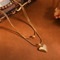 Elegante dubbellaagse gouden roestvrijstalen ketting met een sprankelende hartvormige hanger - Puntig Hart Halsketting / Goud
