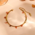 Detailed view of a gold double-layered anklet featuring a snake chain and red stones - Double Layer Bracelet (Red Crystal) / Gold