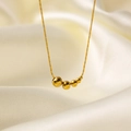 Collar dorado minimalista con cuatro cuentas pulidas sobre fondo de seda blanca - Estilo de Cinco Cuentas de Oro (QYH392) / Dorado