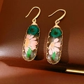 Close-up of sweet resin oval hook earrings with dried pink and teal flowers inside - Ear Hooks-Oval / Pink-Green