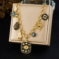 Gold-plated chunky chain necklace with Evil Eye and Hamsa Hand charms on a jewelry box - N4137