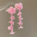 Close-up of pink chiffon flower and bead tassel earrings for a sweet vacation look - Pink