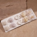 Set of elegant white pearl flower stud earrings displayed on a textured stone surface - 10-Piece Set / Silver Earring Post-White