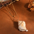 Detailed view of natural seashell pendant on gold double-layered snake chain - Double Layer Necklace / Gold Conch Style