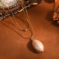 Detail of double-layer stainless steel gold chain necklace with natural cowrie shell - Double Layer Necklace / Golden Light Coffee Conch Style