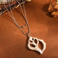 Detail close-up of double-layer stainless steel necklace with natural shell pendant - Double Layer Necklace / Steel Hollow Conch Style