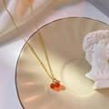 Elegante gouden ketting met rode kersenhanger op een vintage keramisch bord - Kers Ketting Fijne Ketting (QY8026) / Goud