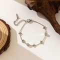 Detailed macro view of silver clover charms and cubic beads on a stainless steel chain - Square Flower Bracelet-Steel Color(QYE265)