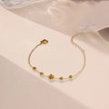 Elegant gold titanium steel bracelet with five blooming camellia charms on white background - Camellia Bracelet / Gold