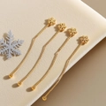 Elegant gold clover leaf dangle earrings with delicate chains on soft beige velvet background - Snowflake (QYG335)