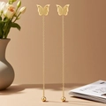 Close-up of golden butterfly tassel earrings with polished wings and long chain bead - Butterfly Tassel (QYG275)