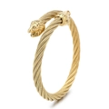 Golden twisted cable bangle with detailed twin lion head carvings and polished finish - Lion Head / Black