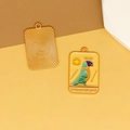 Detail of parrot tarot card enamel pendant with 'The Magician' text in gold finish - L / Yellow Parrot (The Magician)