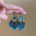 Detailed close-up of bohemian bronze earrings featuring blue shell tassels and beads. - Cyan Shell Disc Style (2# Hook-Green)