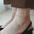 Minimalist gold anklet featuring small cube charms on a delicate chain worn with sandals - Eight Cubes Anklet (B11) / Gold