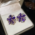 Elegant purple flower stud earrings with sparkling crystals in a velvet jewelry box. - Earrings / Gold-Purple