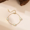 Gold stainless steel heart charm bracelet with white shell inlays on a beige background - Three White Shell Heart Anklet (QYB90)