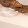 Minimalist LOVE letter pendant necklace with vertical bar on natural wood background - Steel