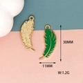 Detail view of green enamel feather pendant showing 30mm height and 11mm width dimensions - Feather Design / Green Feather