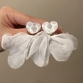 Close-up of elegant white heart studs with airy organza petal drops for summer vacation - White Heart