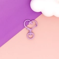 Macro view of a matte purple heart-shaped lobster clasp accessory on a colorful background - Purple