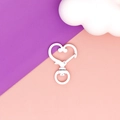 Detail view of a white heart-shaped lobster clasp for DIY keychain and bag accessories. - White