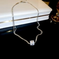 Detail shot of a multi-strand silver necklace with sparkling geometric pavé pendant. - Real Gold Plated Multi-layer Style / Silver
