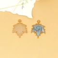 Detailed macro view of gold-plated maple leaf pendants with light blue enamel dripping oil - Maple Leaf Charm (C-296) / Pearlescent Gray