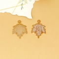 Close-up detail of golden alloy maple leaf pendants with cream enamel drip oil finish - Maple Leaf Charm (C-296) / Pearlescent Coffee