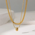 Close-up of double-layered gold necklace with flat herringbone chain and drop pendant - Double Layer Water Drop Style (QYH1257) / Gold