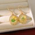 Close-up of elegant oval resin drop earrings featuring colorful real dried flowers - White and Green Hook