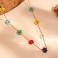 Detailed view of colorful beaded flower charms on a gold titanium steel chain - Colorful Solid Flower Bead Necklace