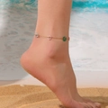 Close-up detail of a colorful floral charm anklet worn on an ankle at a sunny beach. - Colorful Transparent Flower Bead Anklet