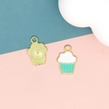 Detailed view of a mint green and white enamel cupcake charm for DIY jewelry making projects. - 2 Green Dessert