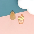 Close-up of cute cupcake enamel pendant with heart detail and textured gold back - 4 Butter Cake