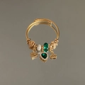 Gold cable bangle featuring green heart gemstone and crown charms on grey surface - Exquisite Beaded Style (B1089—3)