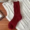 Rote Thermo-Wollsocken für Damen im Rippstrick-Design auf weißem Pullover liegend - Gesaumte Kante Stil