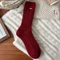 Deep red wool knit mid-calf sock with cable pattern and gold metal accent label - Cable Knit With Gold Tag Style
