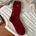 Deep burgundy mid-calf wool socks featuring ribbed cuffs and a small golden metal accent - Flat Knit With Gold Tag Style