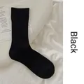 Minimalist black cotton crew socks with vertical ribbed knit texture for women - One Size / Black