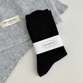 Classic black mid-calf socks with vertical texture and minimal paper wrap packaging - One Size / Black