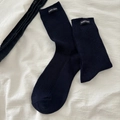 Dark blue ribbed crew socks featuring a woven fabric label with stylish white text - Navy Blue