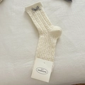 Cream white cable knit crew socks with a grey bow detail on a soft white bed sheet - Cream Bow