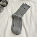 Graue Ripp-Socken für Damen mit braunem Schleifenknopf und Strickstruktur - Einheitsgröße / Hellgrau